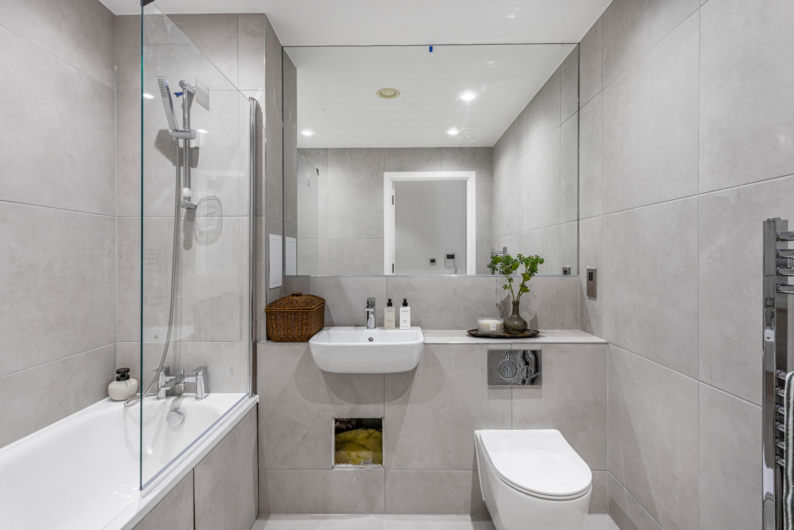 A bathroom with a bathtub, shower, sink, and toilet.