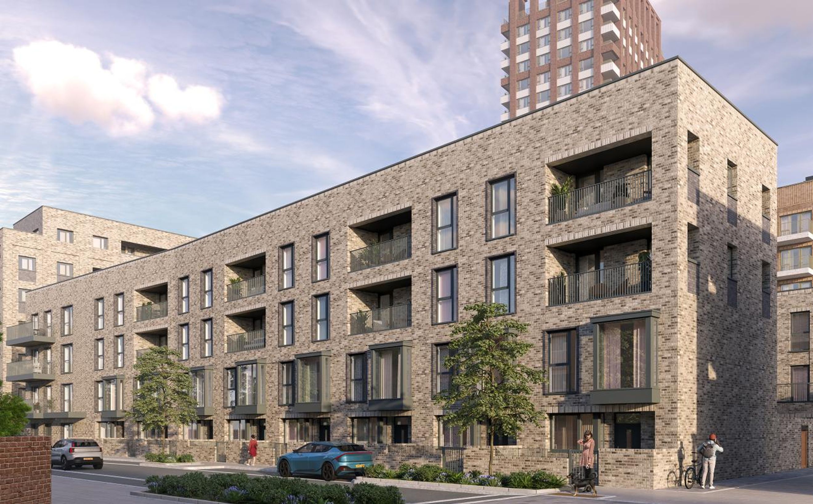 A modern brick apartment building with balconies and large windows.
