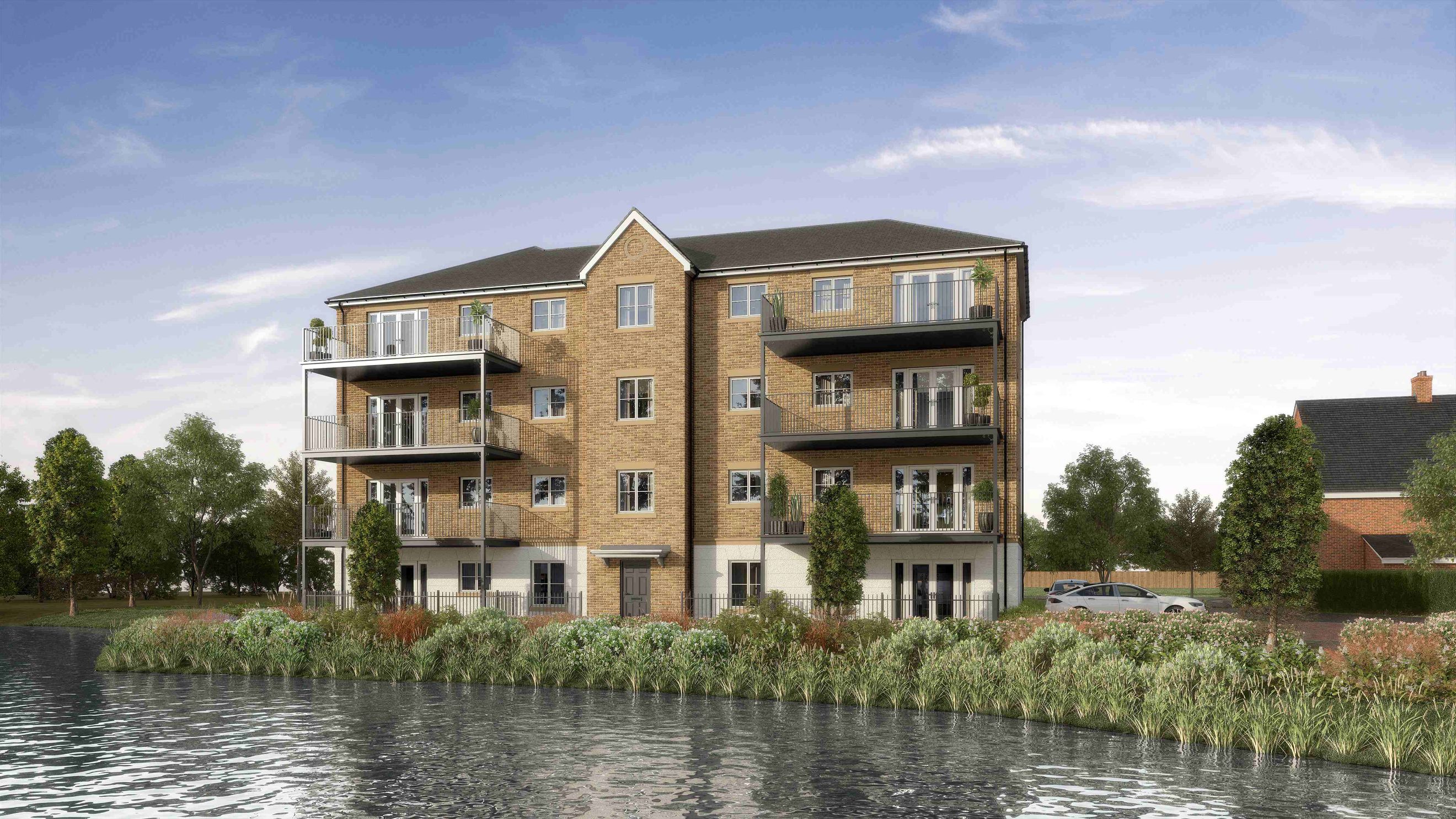 A waterside apartment building with balconies and surrounding greenery.