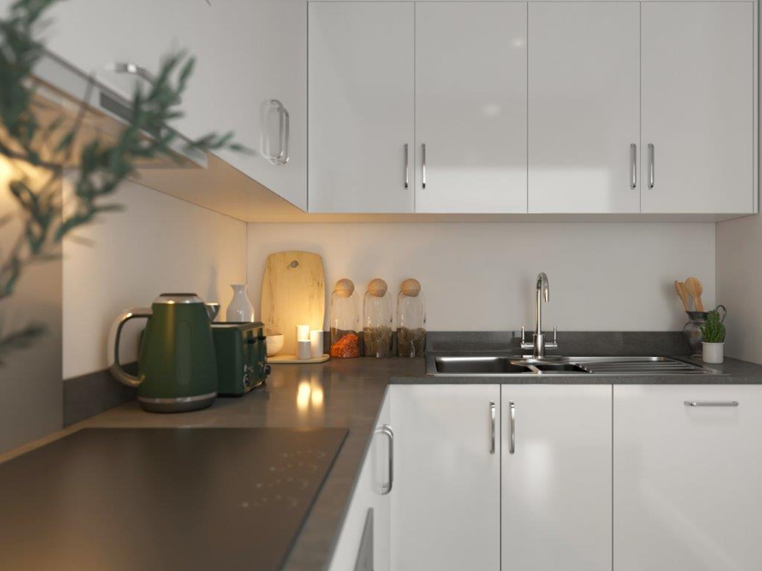 A modern kitchen with white cabinets, a dark countertop, and a stainless steel sink.