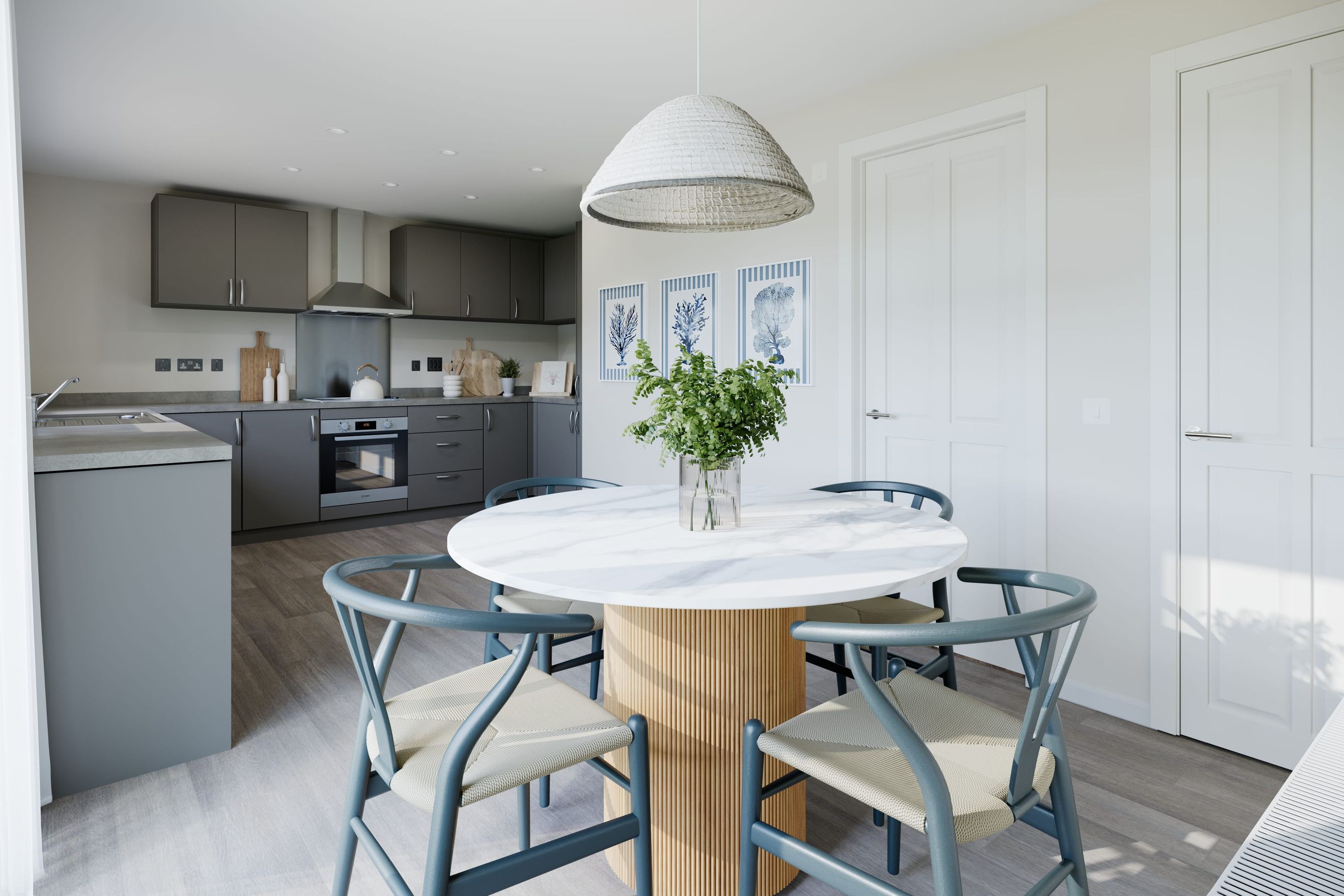 A dining area with a round table and chairs next to a kitchen.