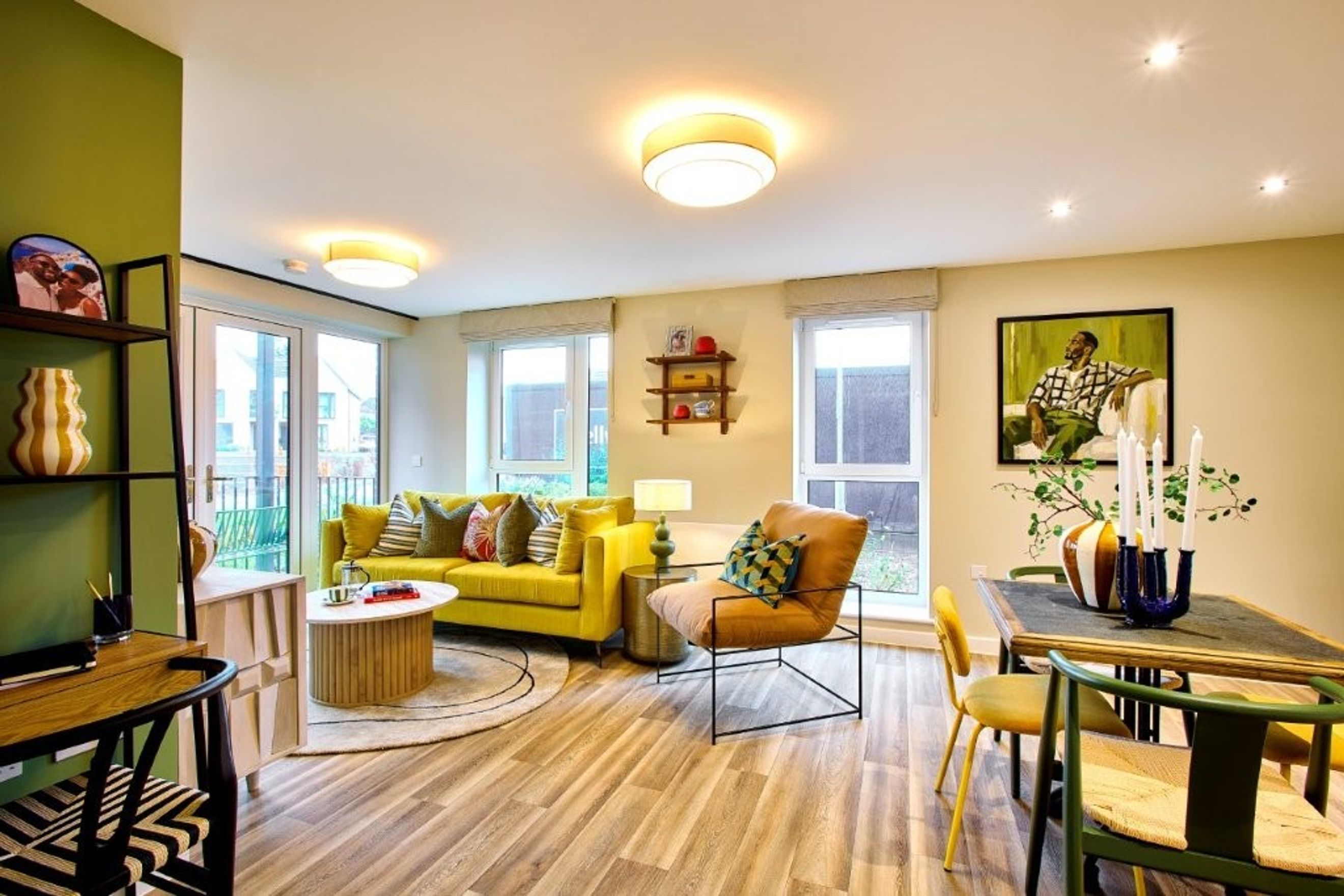 A living room with a yellow sofa, armchair, coffee table, and a dining area.