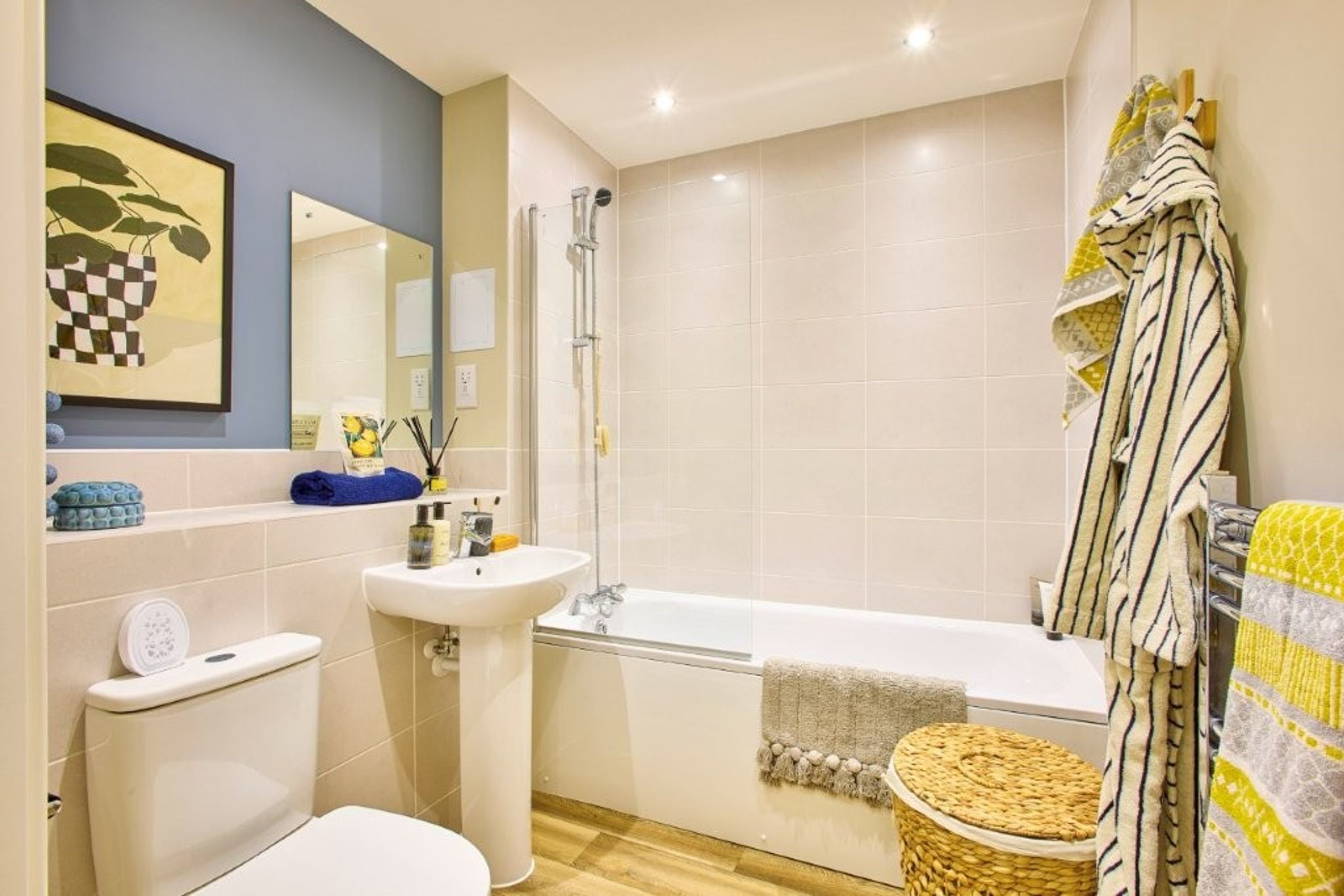 A bathroom with a toilet, sink, and bathtub.