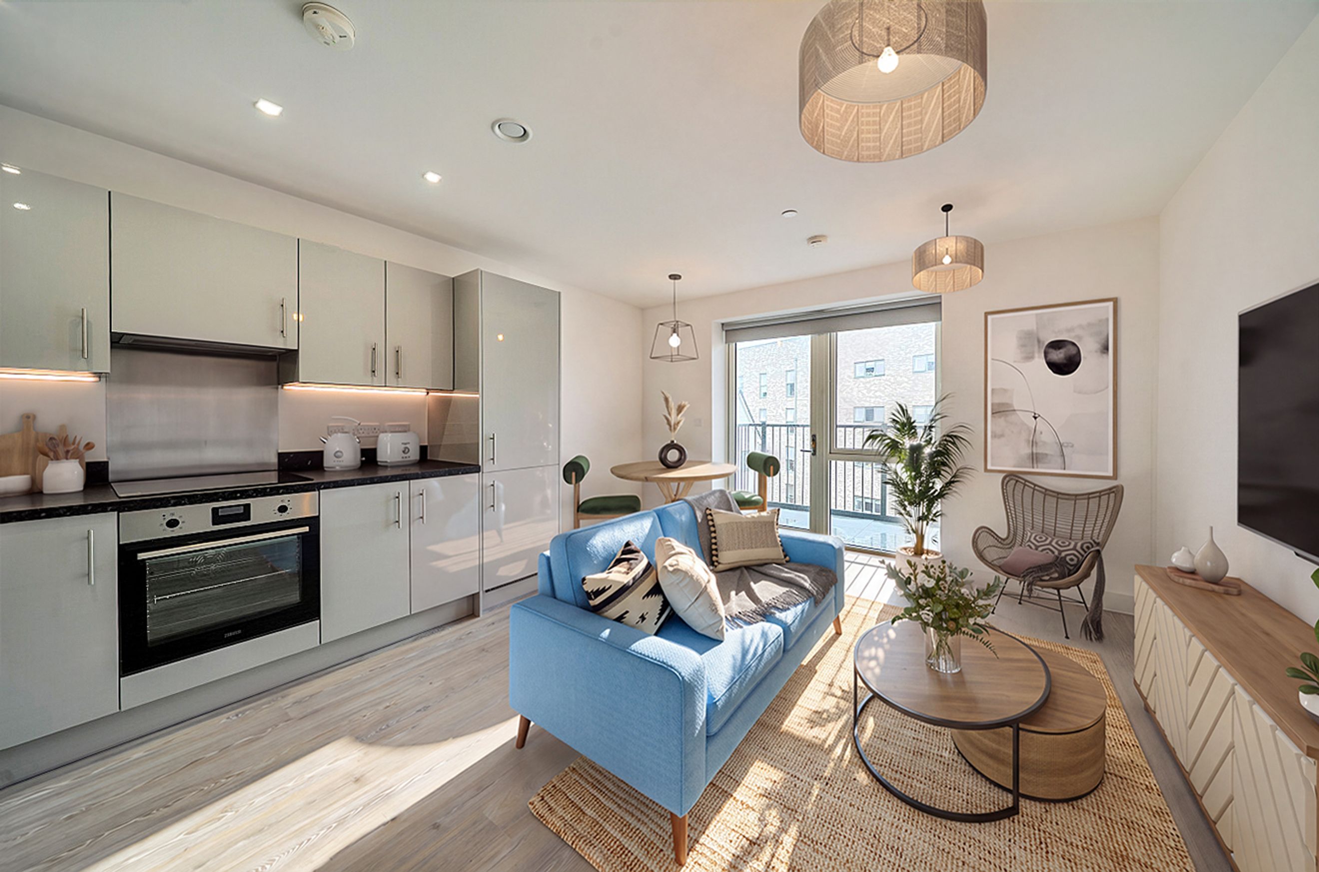 A living room and kitchen area with a blue sofa, coffee table, and kitchen cabinets.