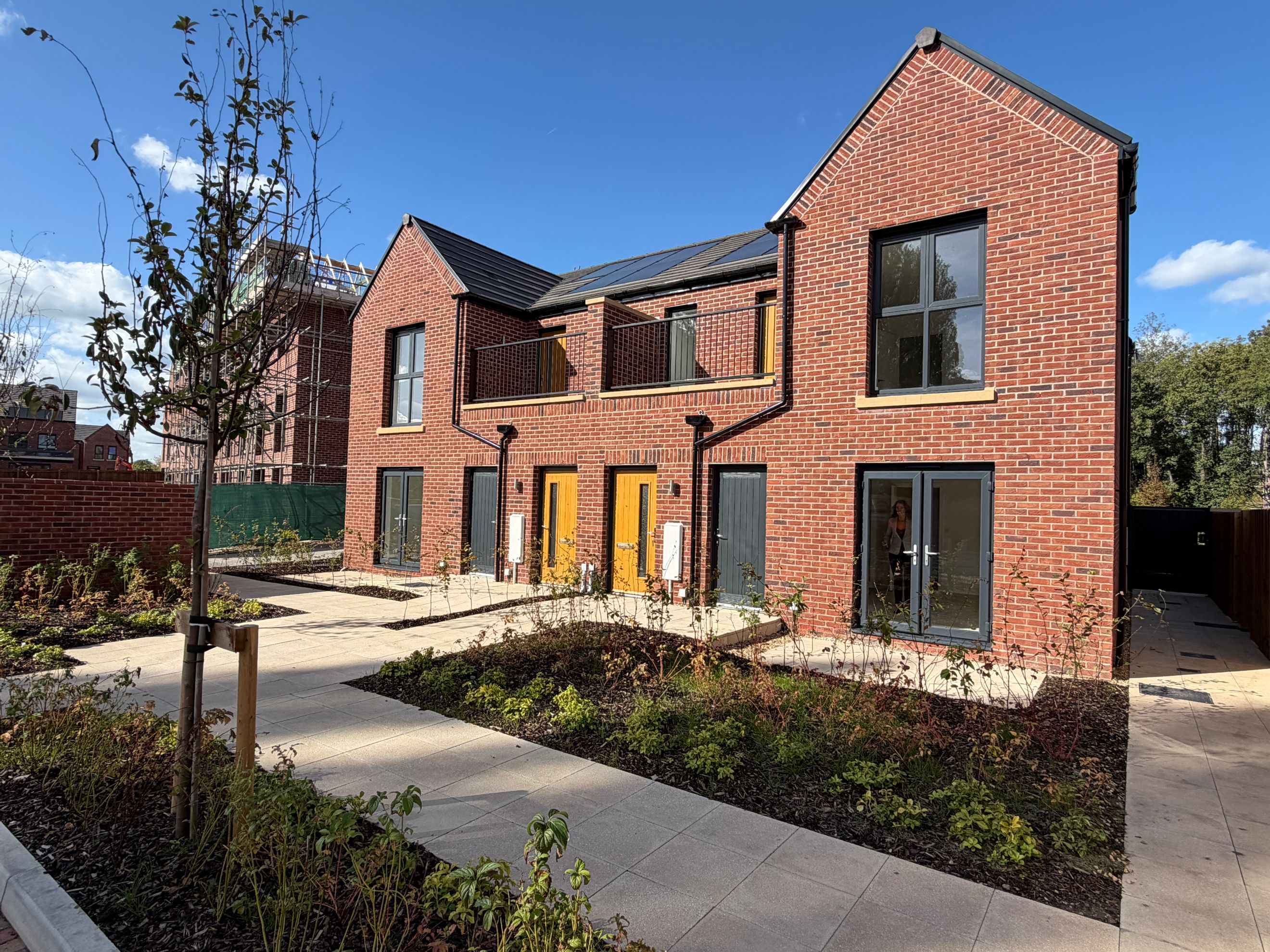 A row of new brick houses with modern windows and doors.