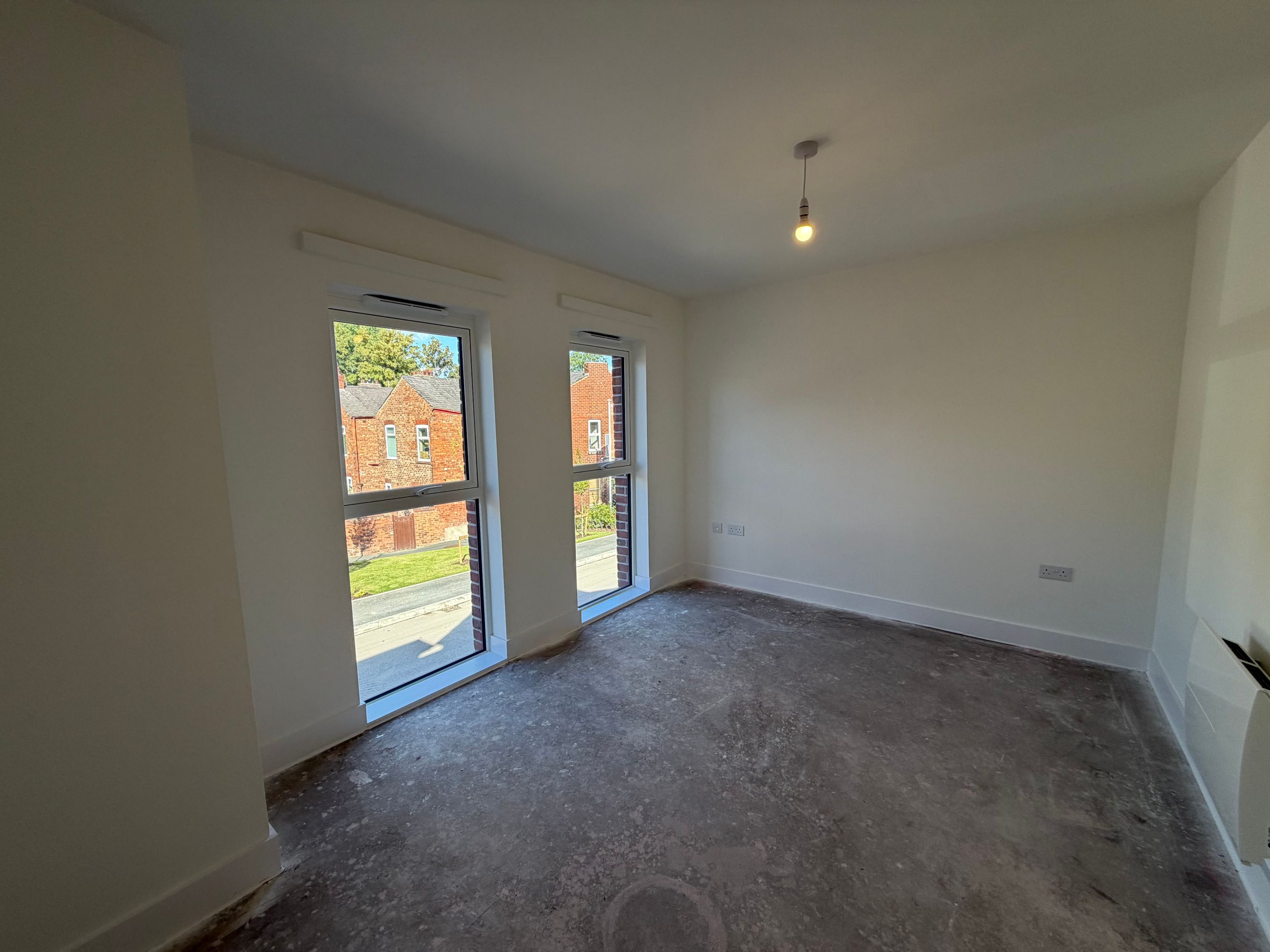 A room with two windows and a light fixture.