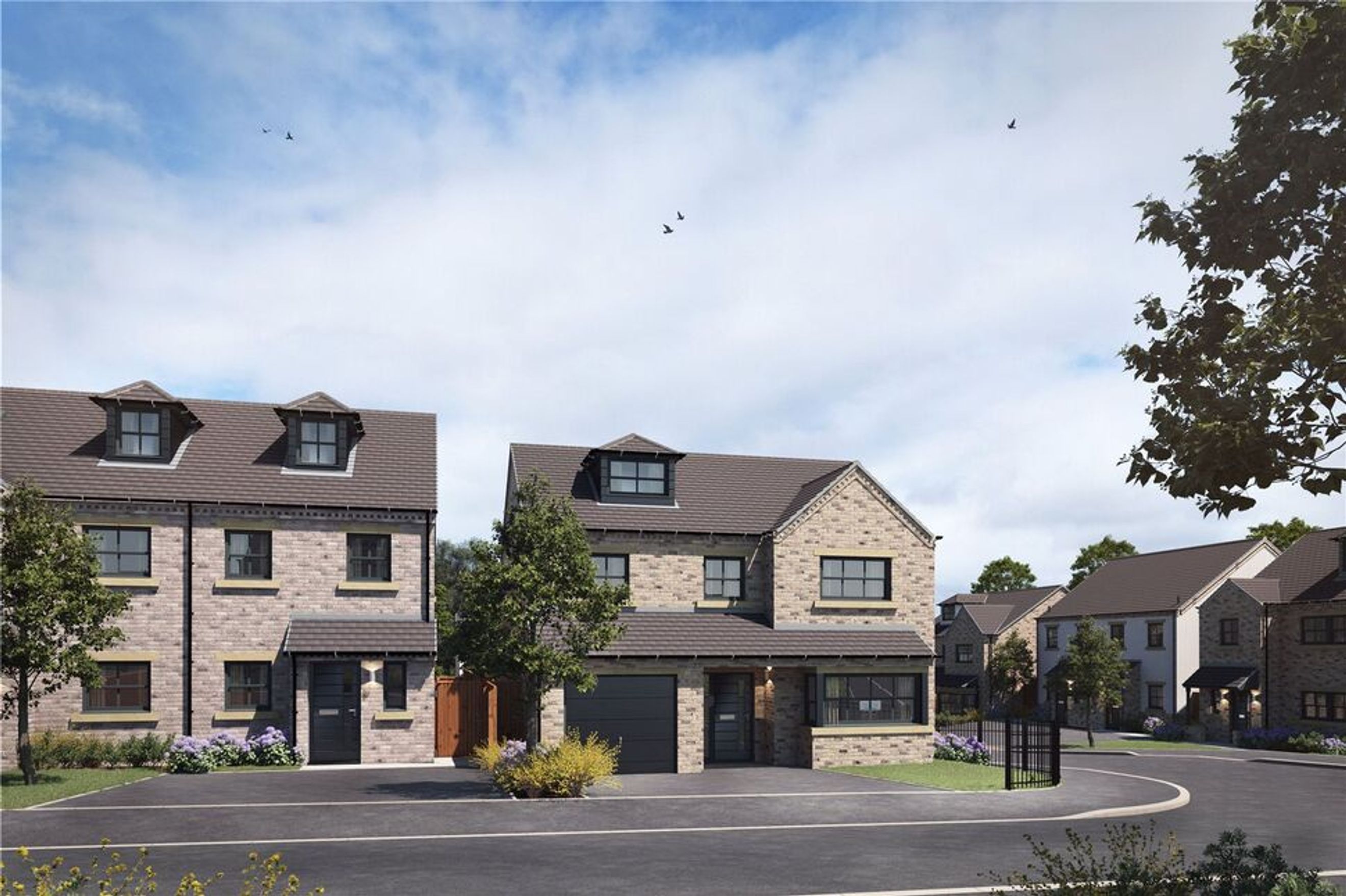 A street view of modern houses with stone exteriors and dormer windows under a cloudy sky.