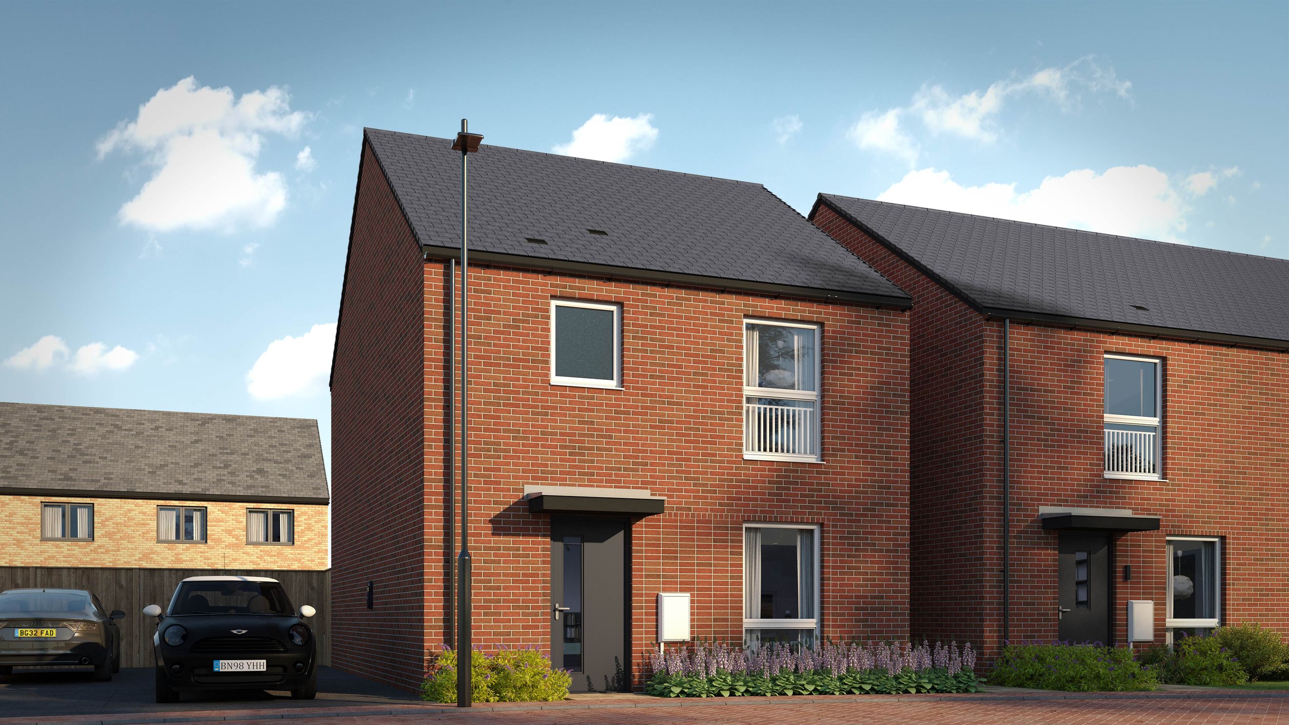 A row of modern brick houses with cars parked in front.