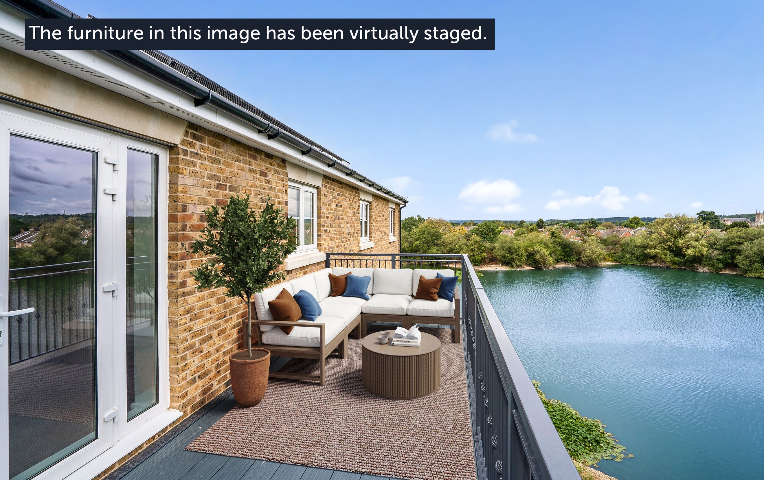 A balcony with outdoor furniture overlooking a lake.