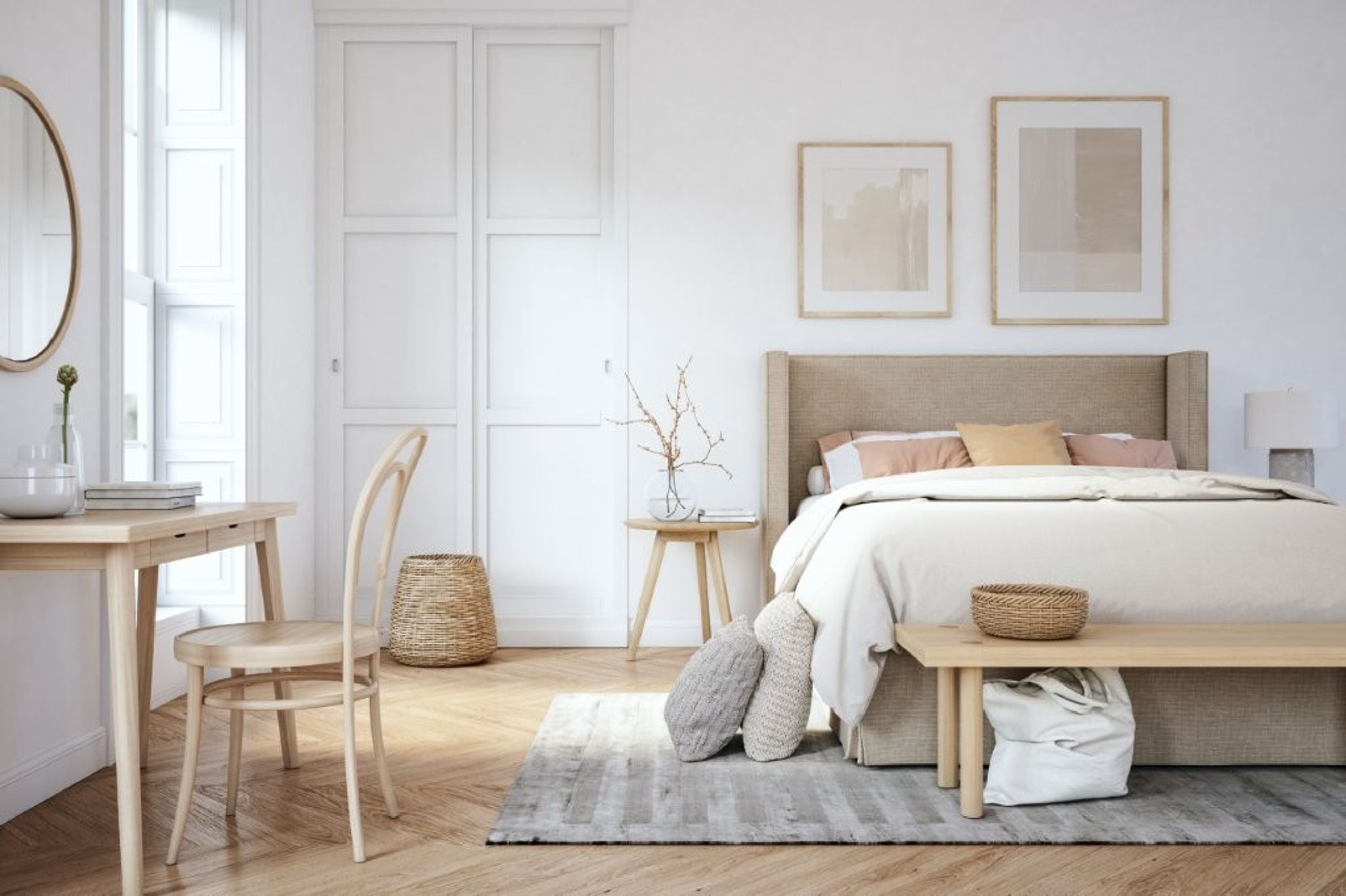 A bedroom with a bed, desk, chair, and artwork.