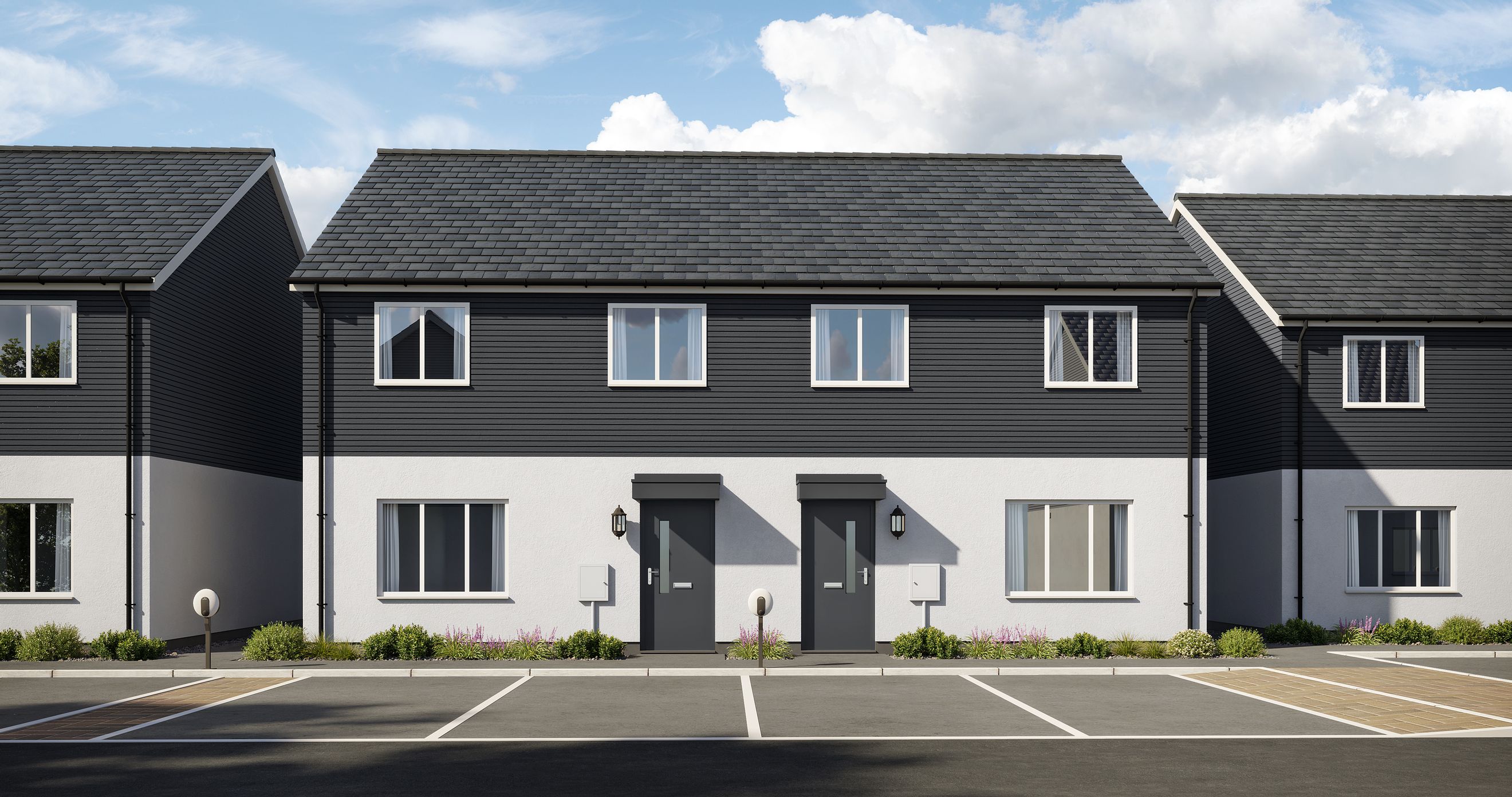 A row of modern semi-detached houses with dark siding and white lower walls.