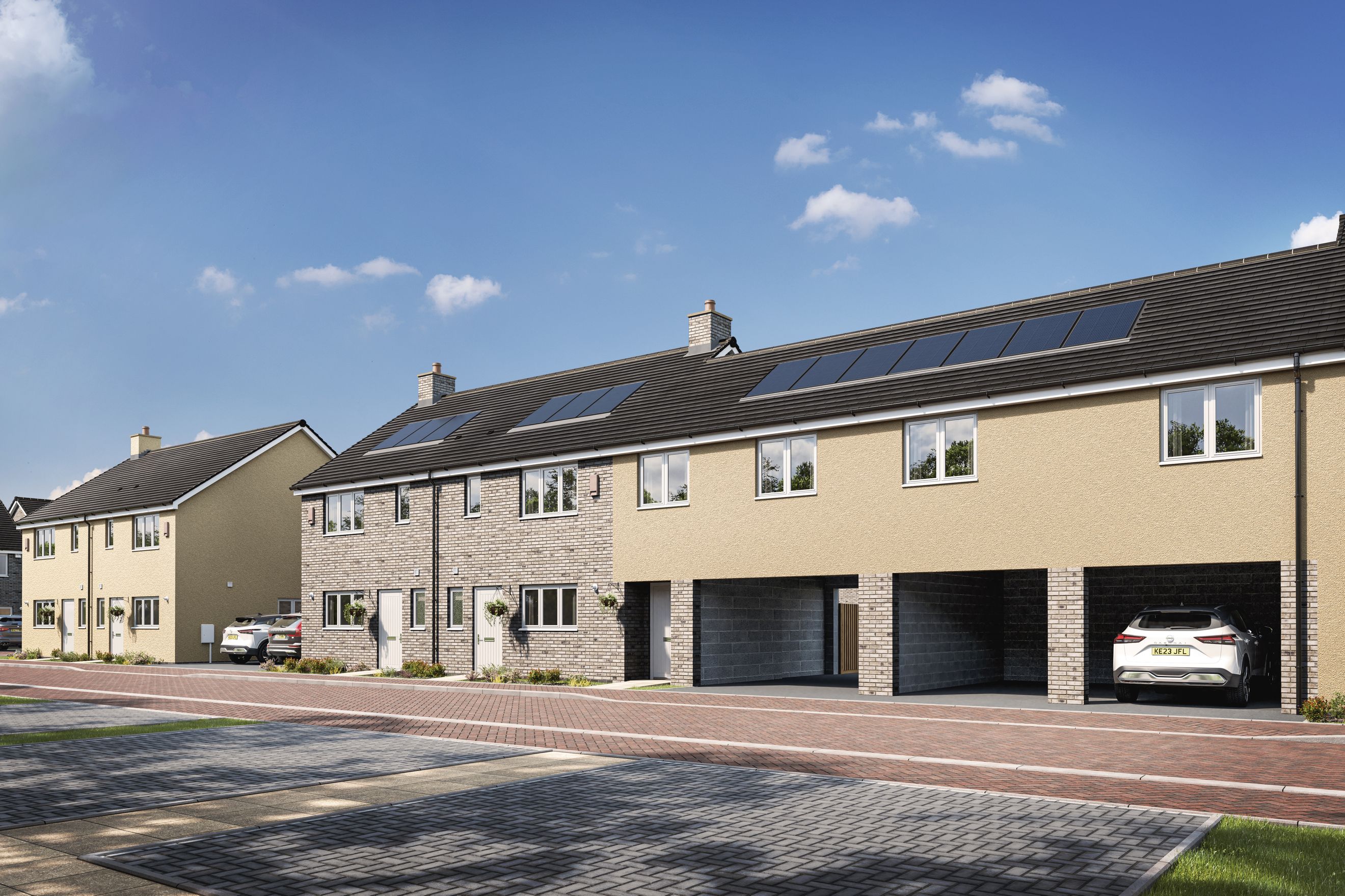 A row of modern townhouses with solar panels on the roof and carports.