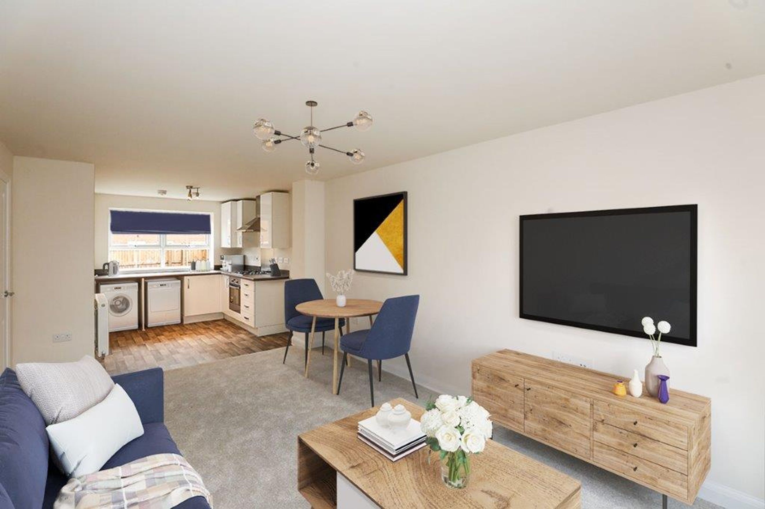 A living room and kitchen area with a sofa, dining table, and kitchen appliances.