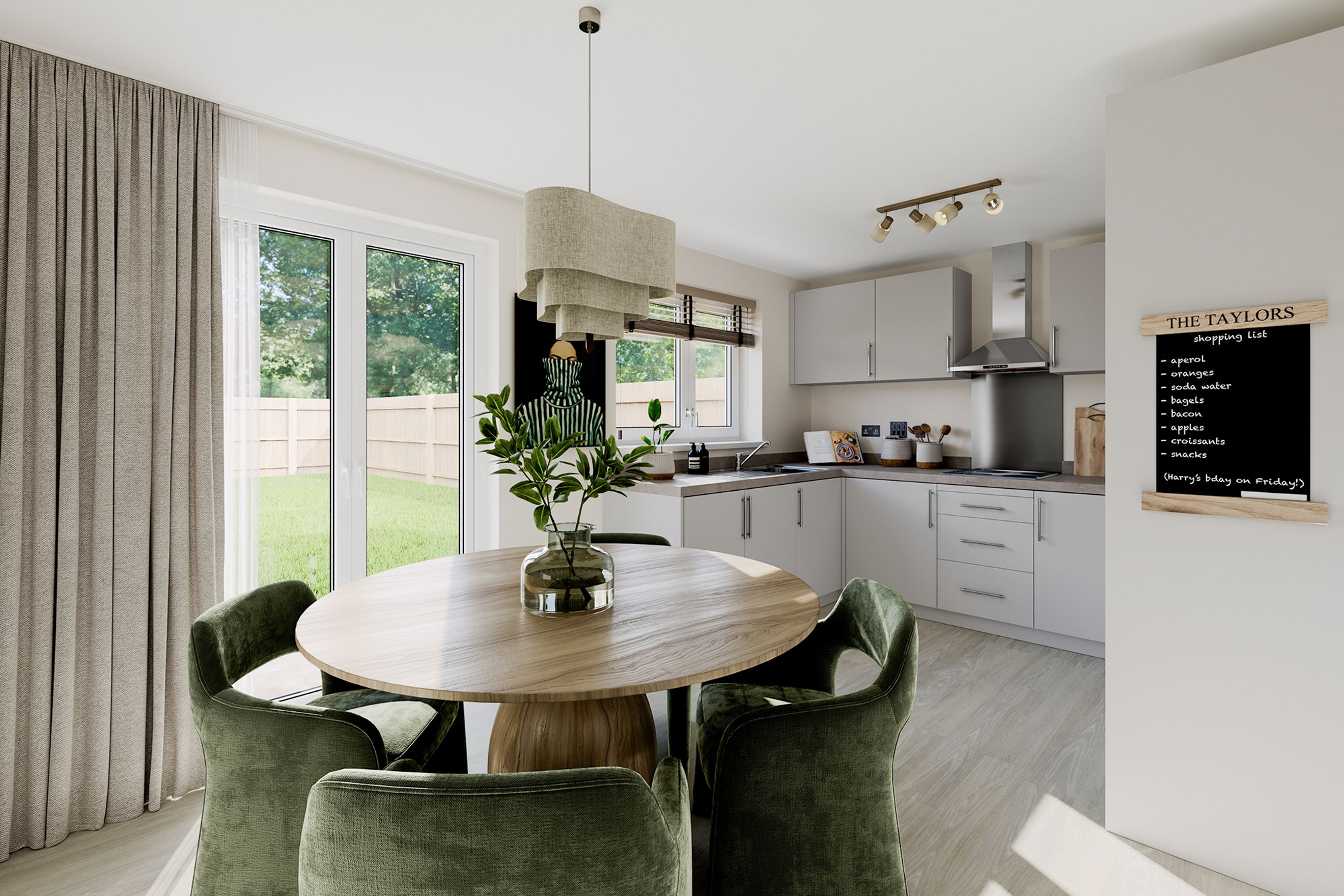A kitchen and dining area with a round table, green chairs, and light grey cabinets.