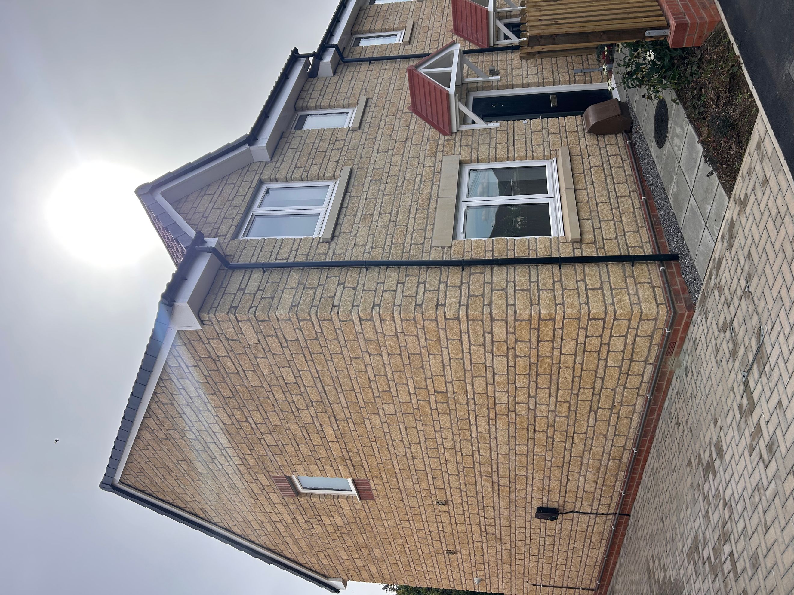 A house with a brick facade and white-framed windows.