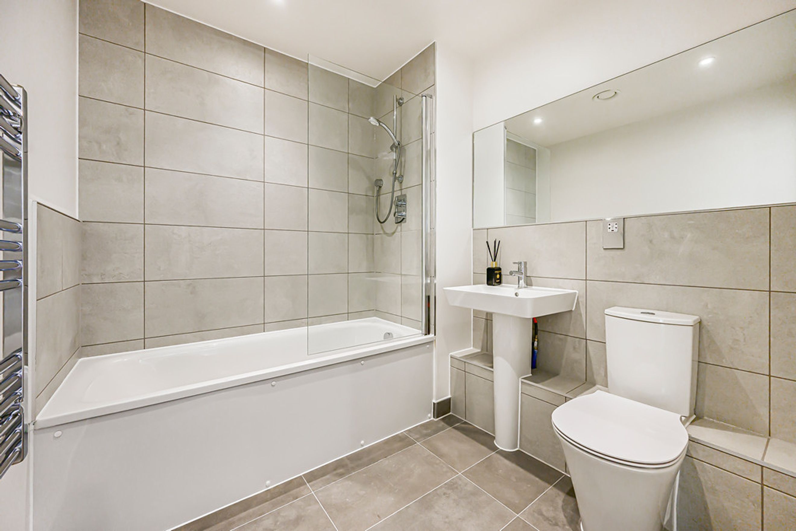A bathroom with a bathtub, a sink, and a toilet.