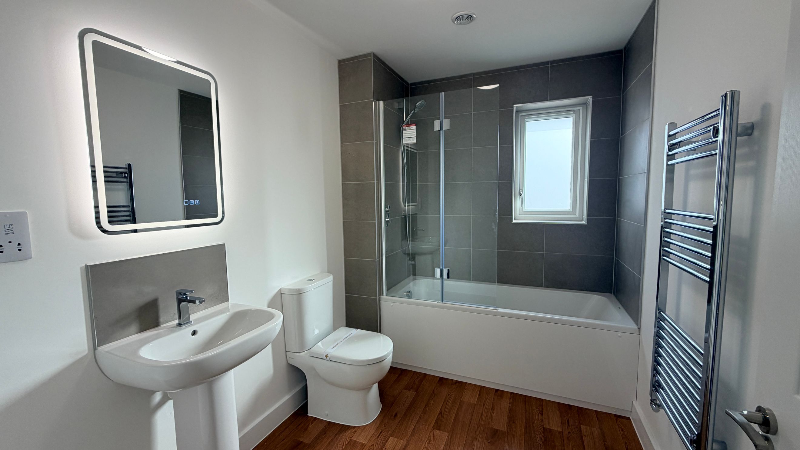 A bathroom with a sink, toilet, and bathtub.