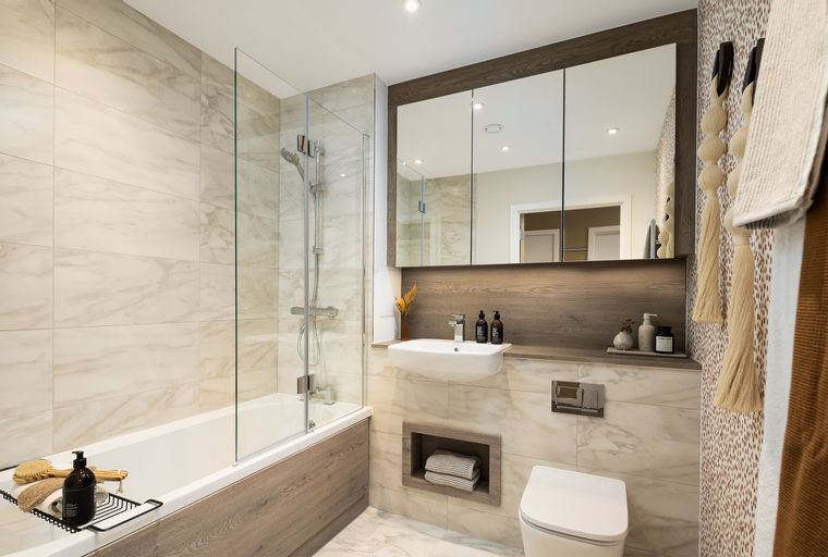 A bathroom with a bathtub, sink, and toilet.