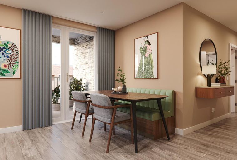 A dining area with a table, banquette, chairs, and artwork.