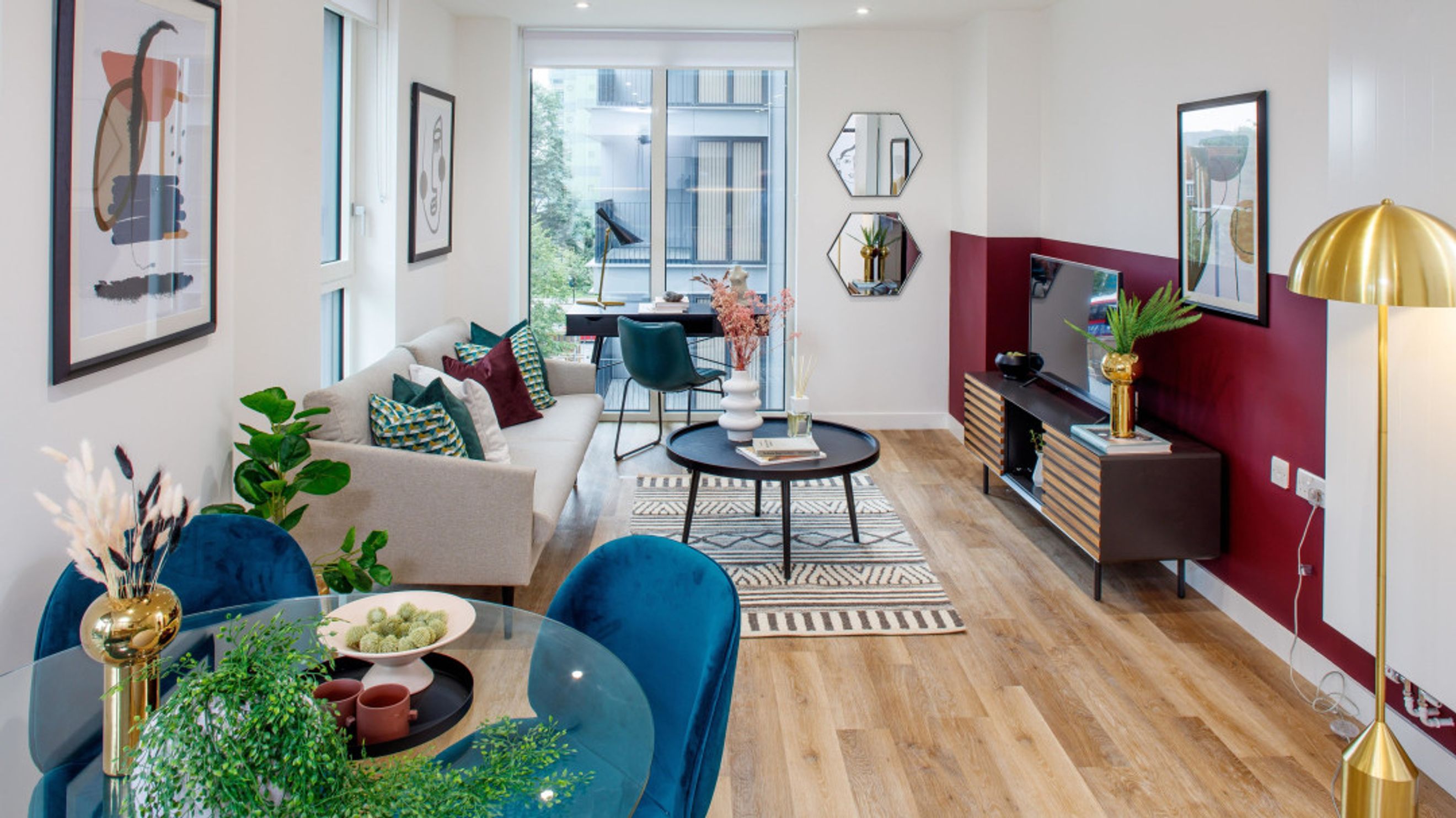 A living room with a sofa, coffee table, and a TV stand.