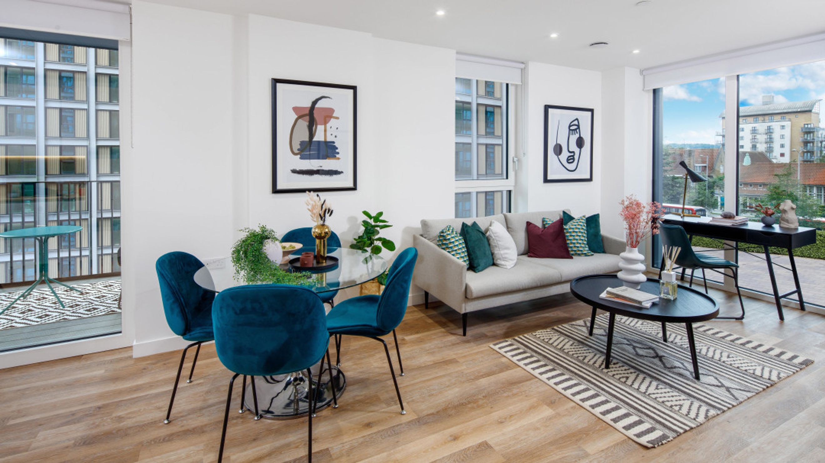A living and dining area with a sofa, coffee table, dining table, and chairs.