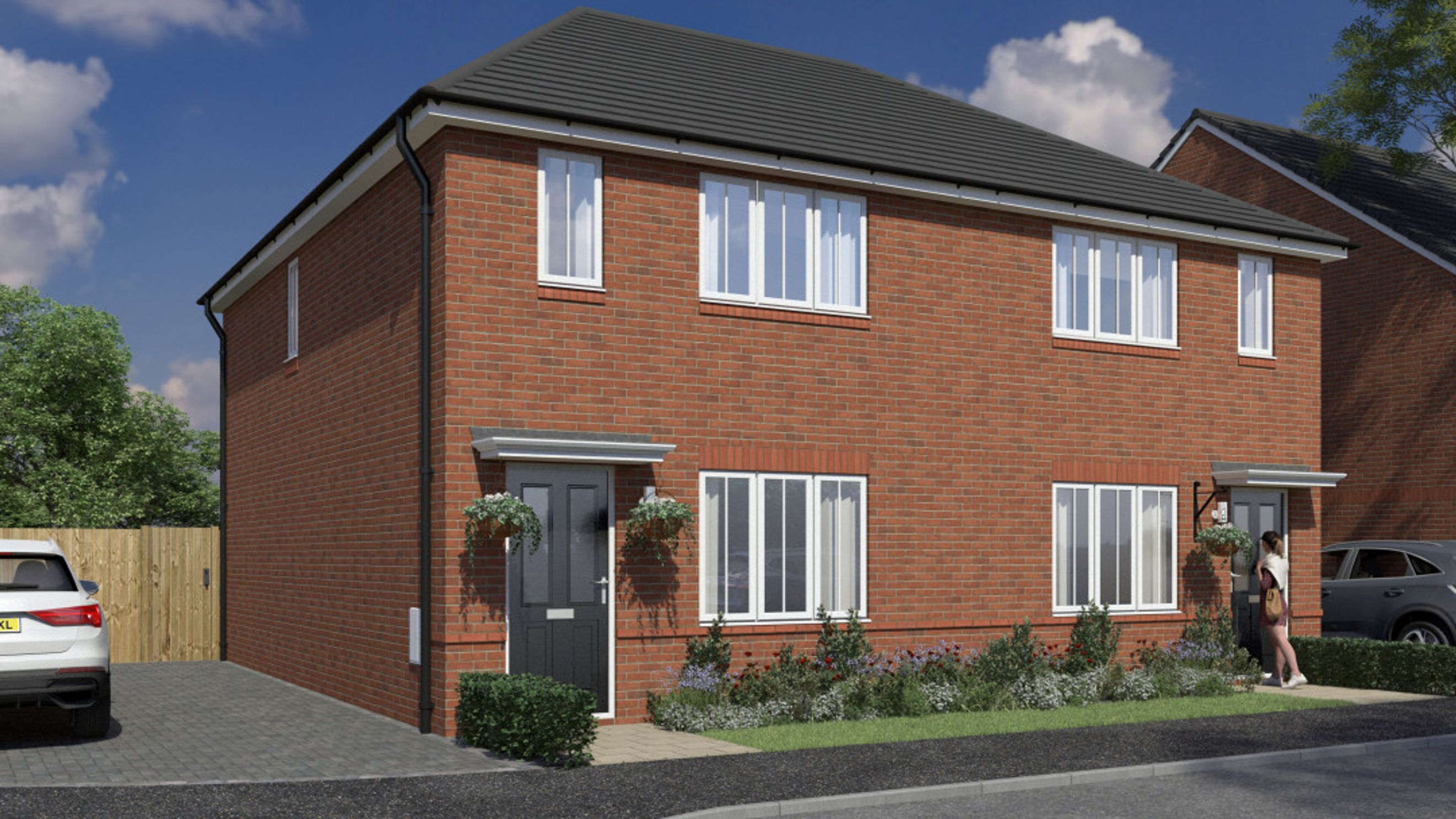 A red brick house with a driveway and a garden.