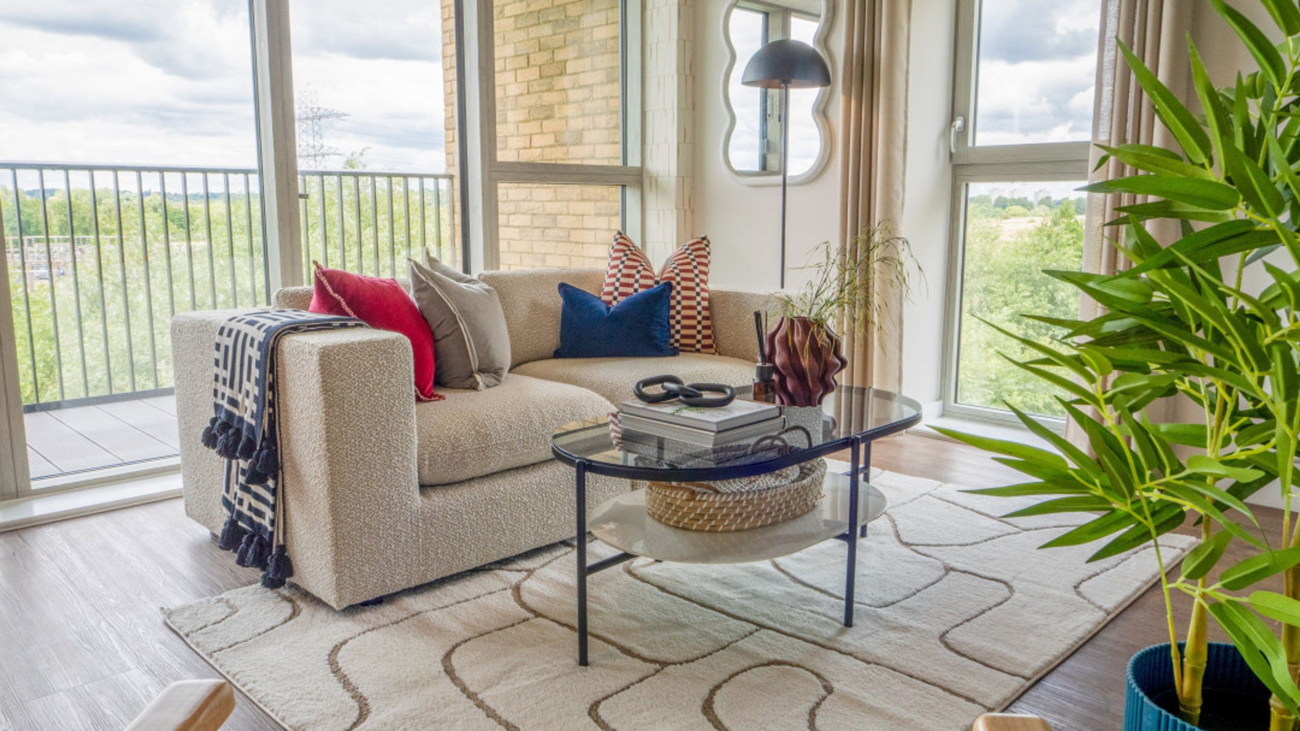 A living room with a sectional sofa, coffee table, and a large window.