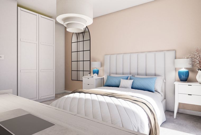 A bedroom with a bed, bedside tables, a wardrobe, and a mirror.