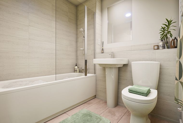 A bathroom with a bathtub, sink, and toilet.