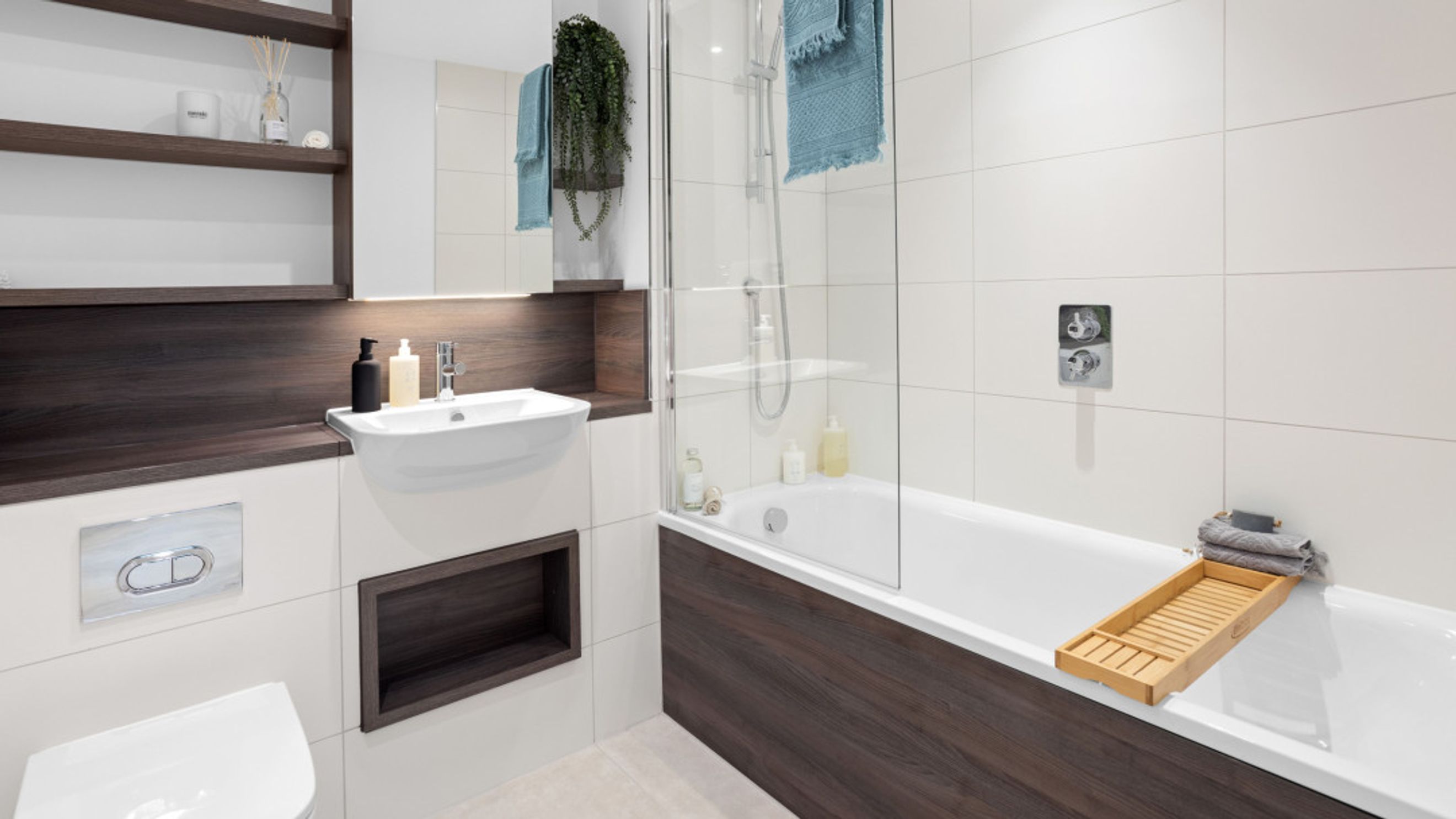 A bathroom with a sink, toilet, and bathtub.