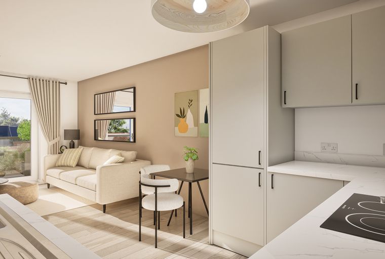 A living room and kitchen area with a sofa, dining table, and kitchen cabinets.