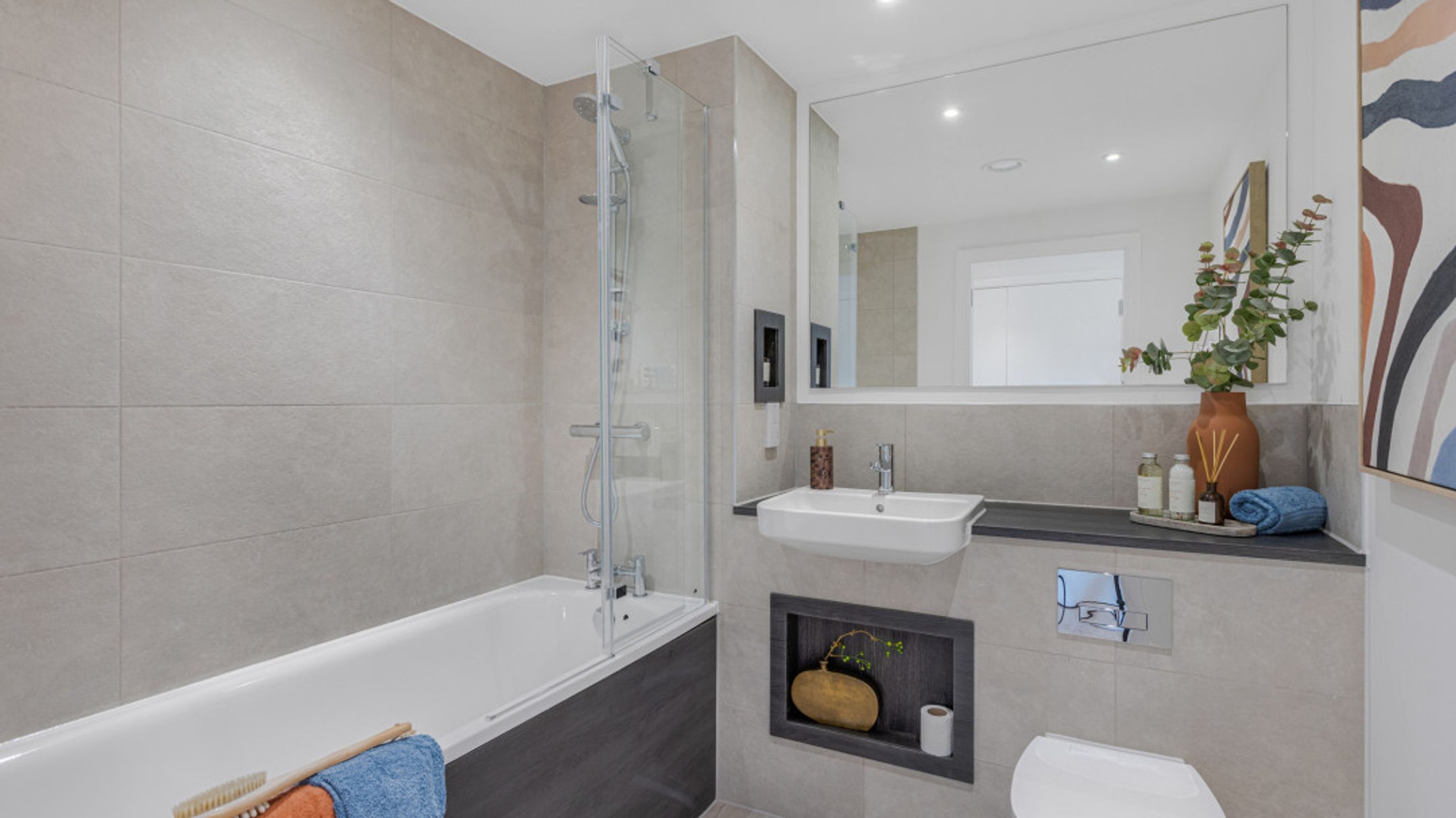 A bathroom with a bathtub, a sink, and a toilet.
