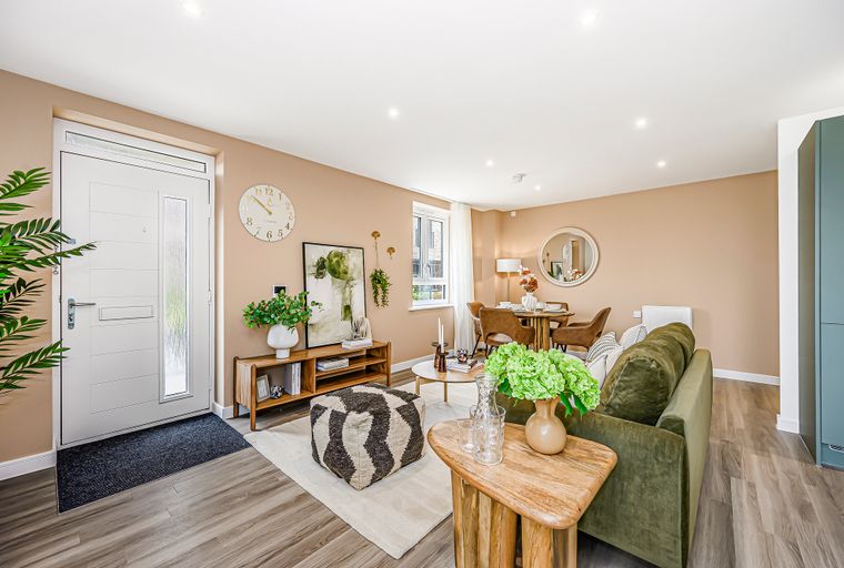A living and dining area with a sofa, dining table, and chairs.