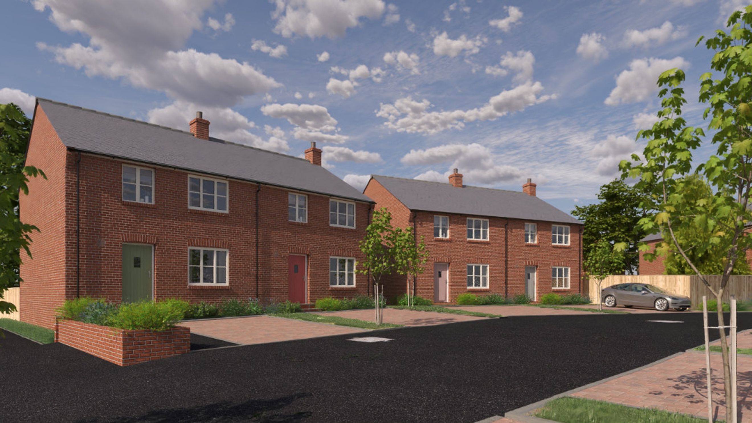 A row of brick townhouses with pitched roofs and multi-pane windows.