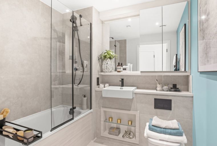 A bathroom with a bathtub, shower, sink, and toilet.