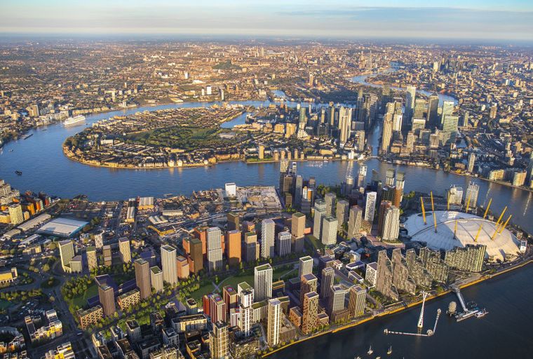 An aerial view of a modern city skyline with a river and the O2 Arena.