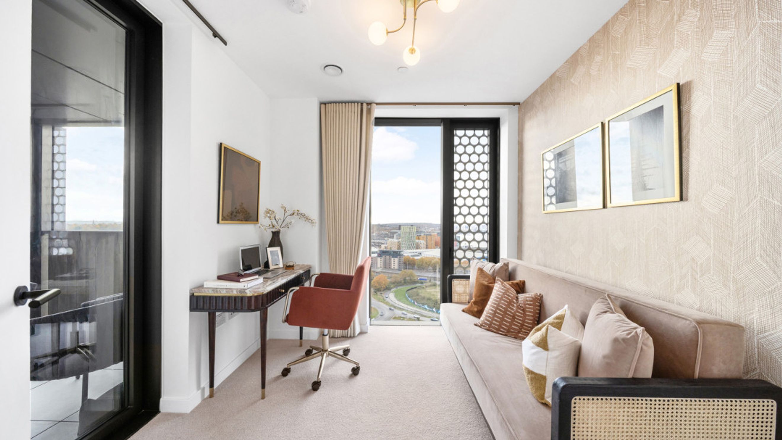 A home office with a desk, chair, and sofa.