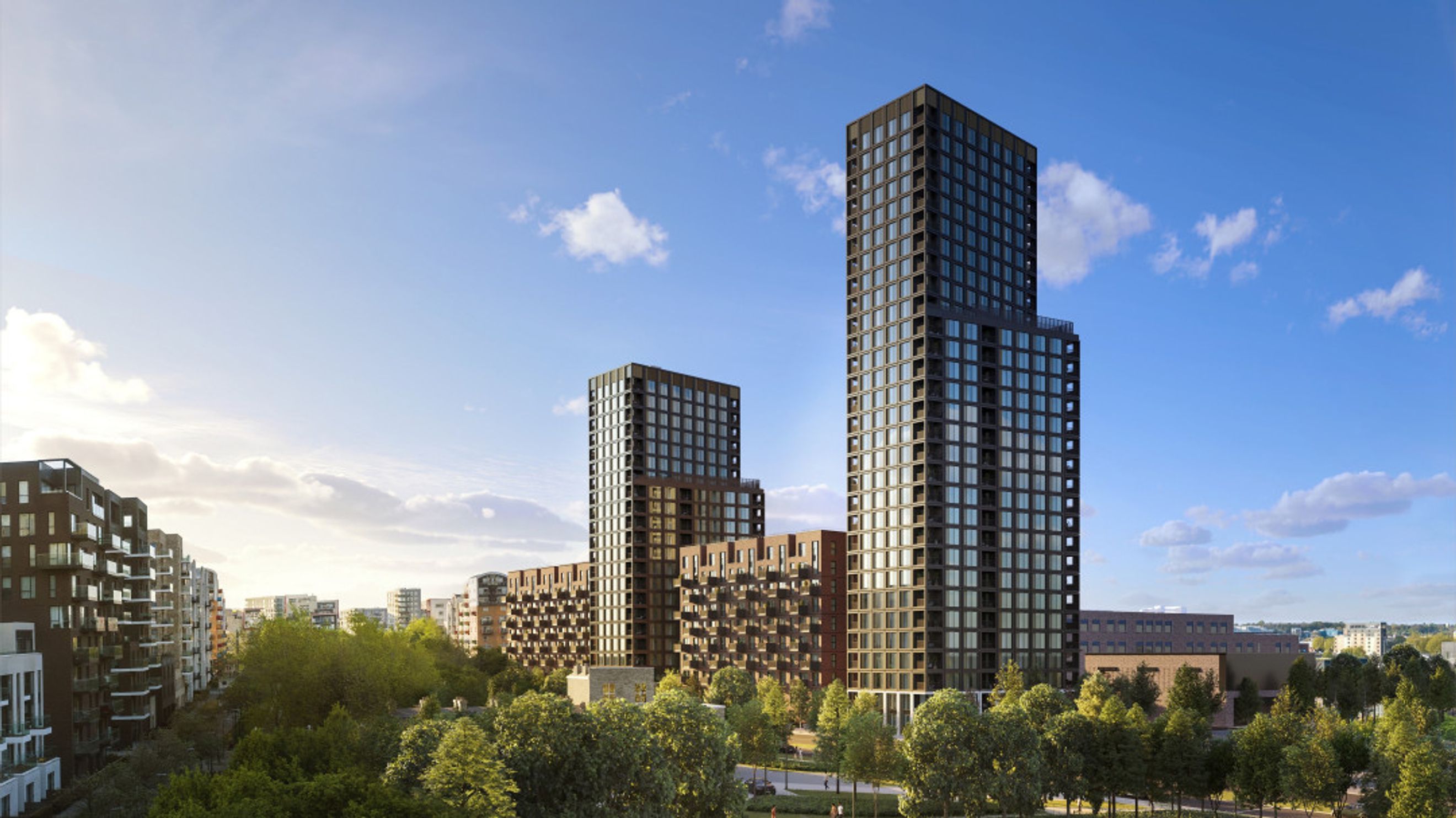A cityscape with modern apartment buildings and trees under a blue sky with clouds.