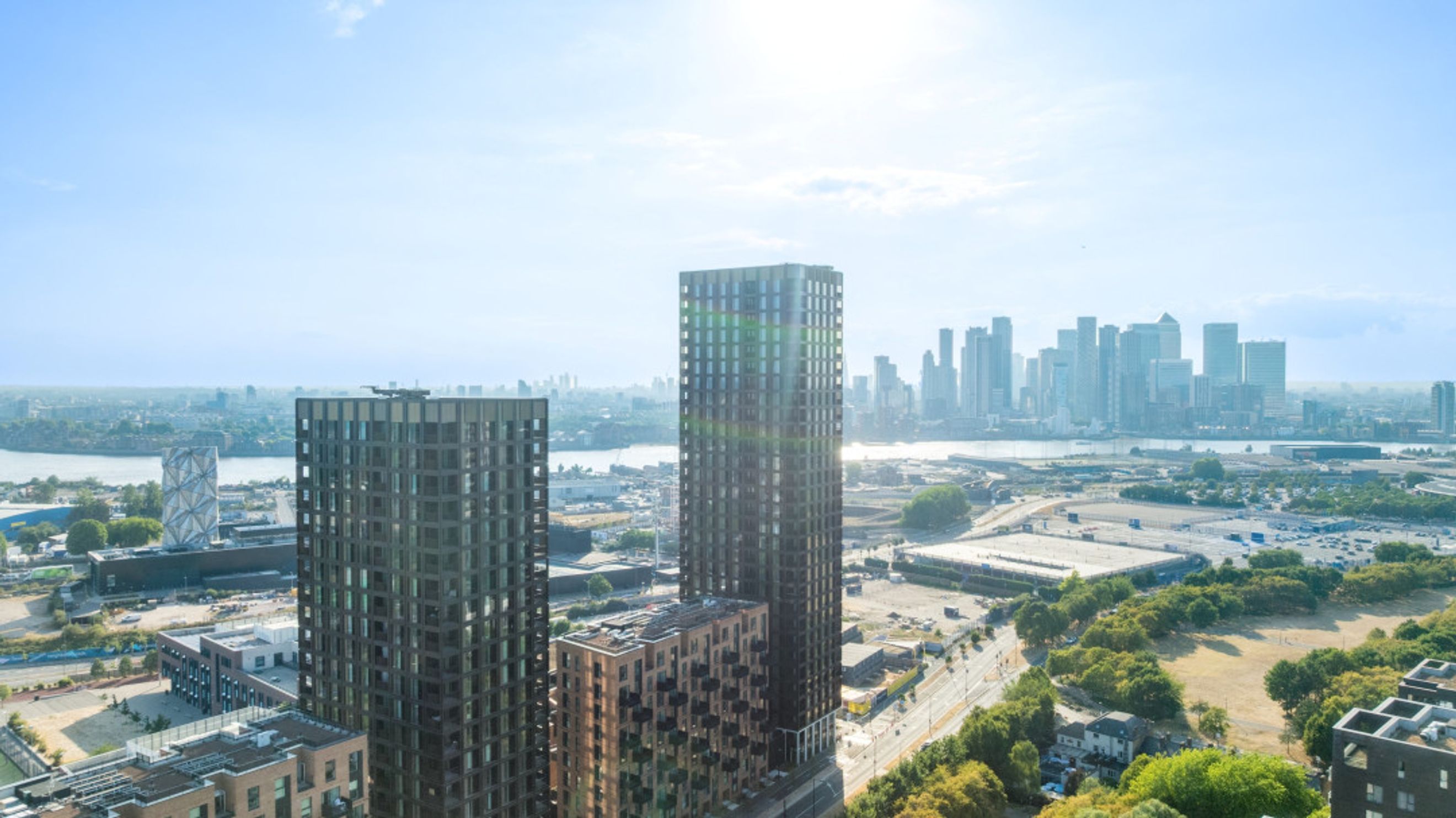 A cityscape with modern high-rise buildings and a distant skyline.