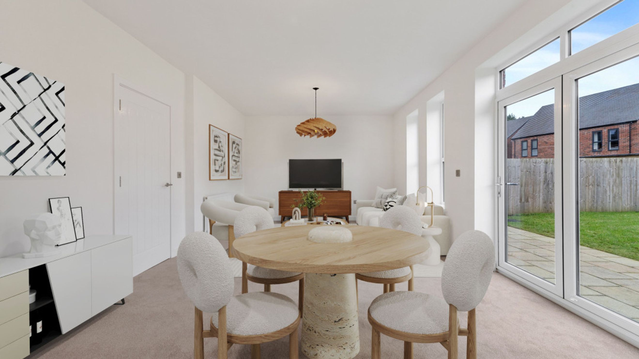 A dining area with a round wooden table and chairs in front of a sofa and television.