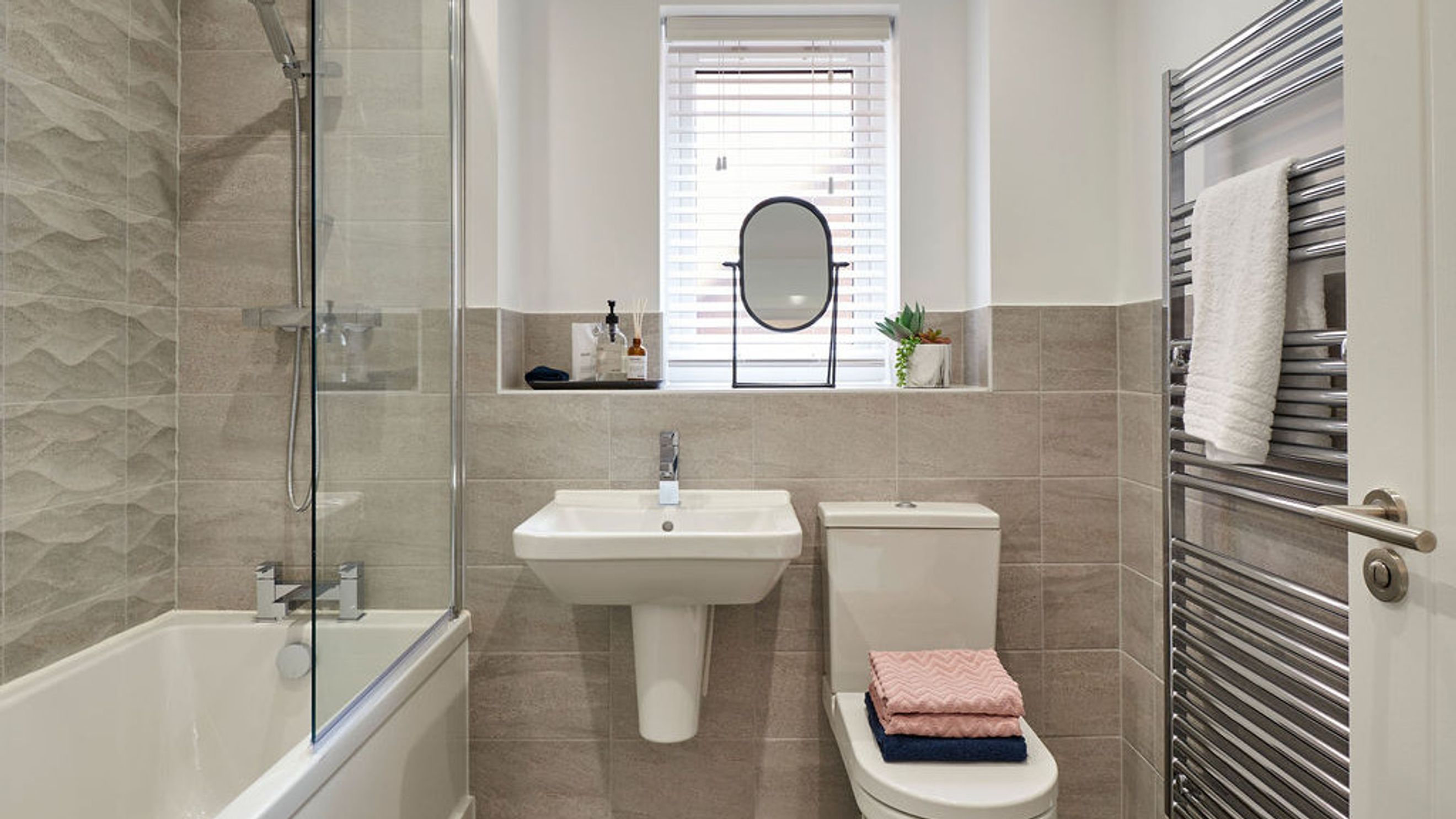 A bathroom with a bathtub, shower, sink, and toilet.
