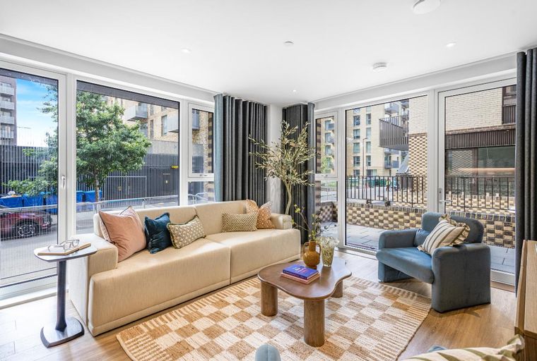 A living room with a sofa, coffee table, and armchair.