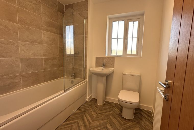 A bathroom with a bathtub, a sink, and a toilet.