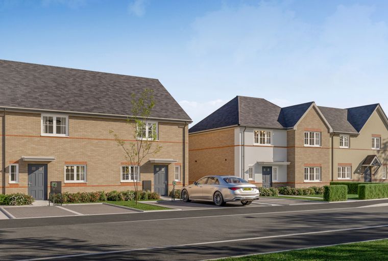 A row of modern townhouses with brick and render facades, parked cars, and manicured landscaping.