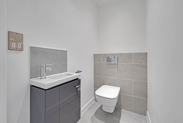 A bathroom with a sink and a toilet.