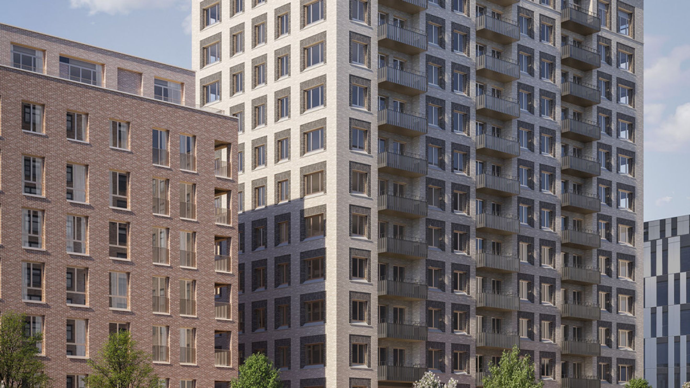 A modern apartment building with brick and light-colored masonry facades, featuring numerous windows and balconies.