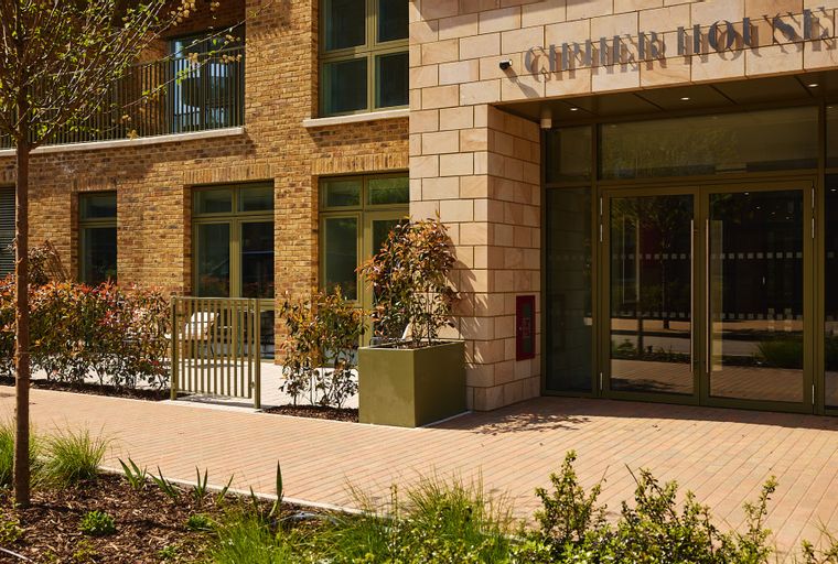 A building entrance with glass doors and signage that reads 'CHIMNEY HOUSE'.