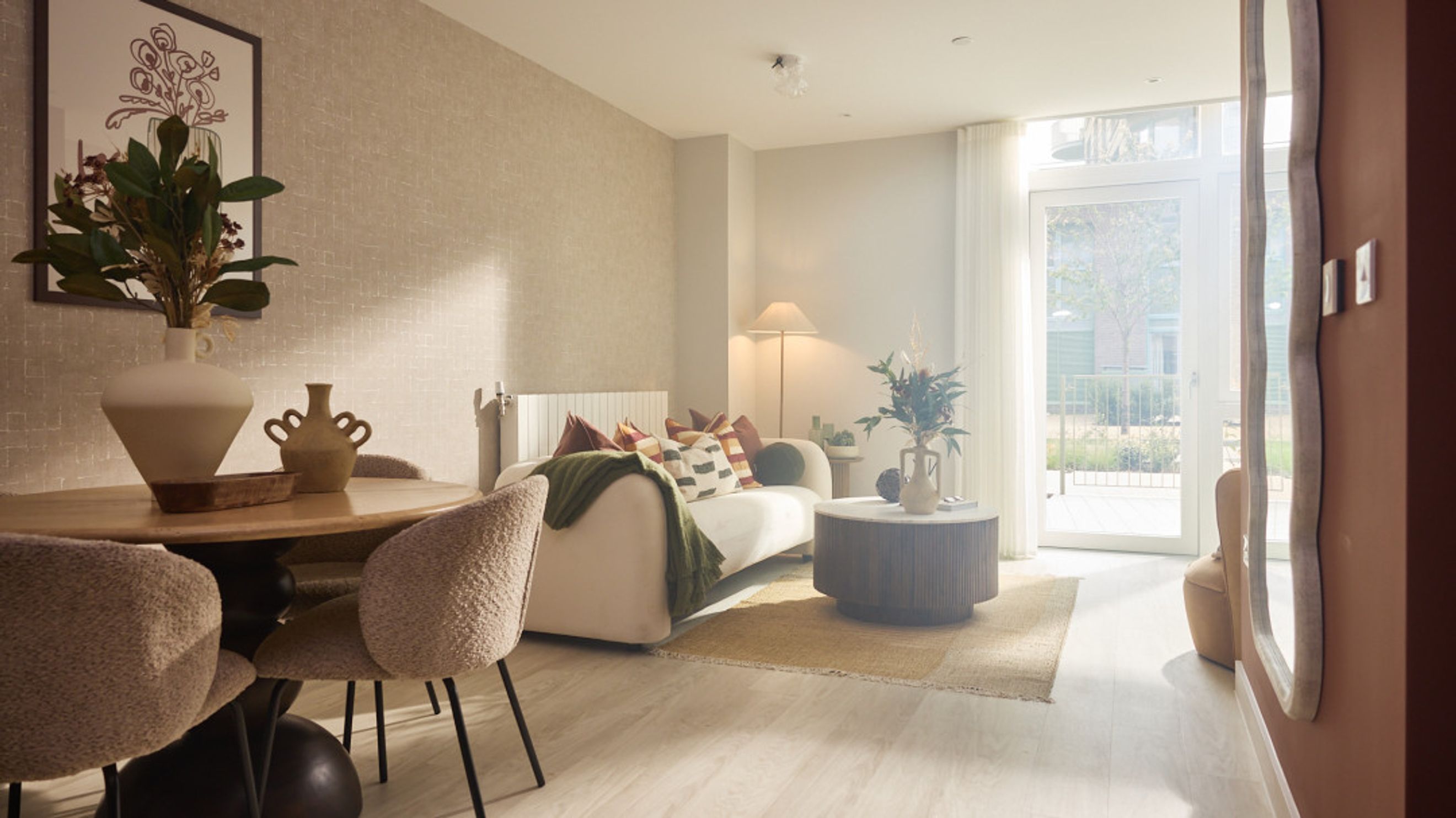 A living room with a sofa, coffee table, and dining table.
