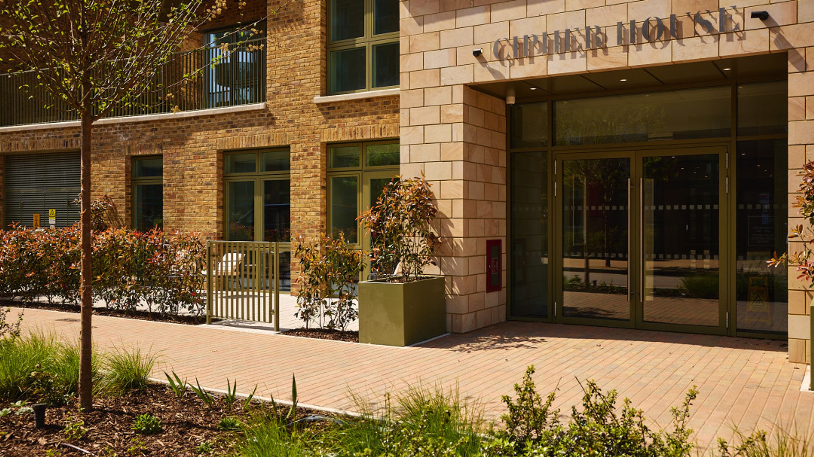 A building entrance with glass doors and signage that reads 'CHIMNEY HOUSE'.
