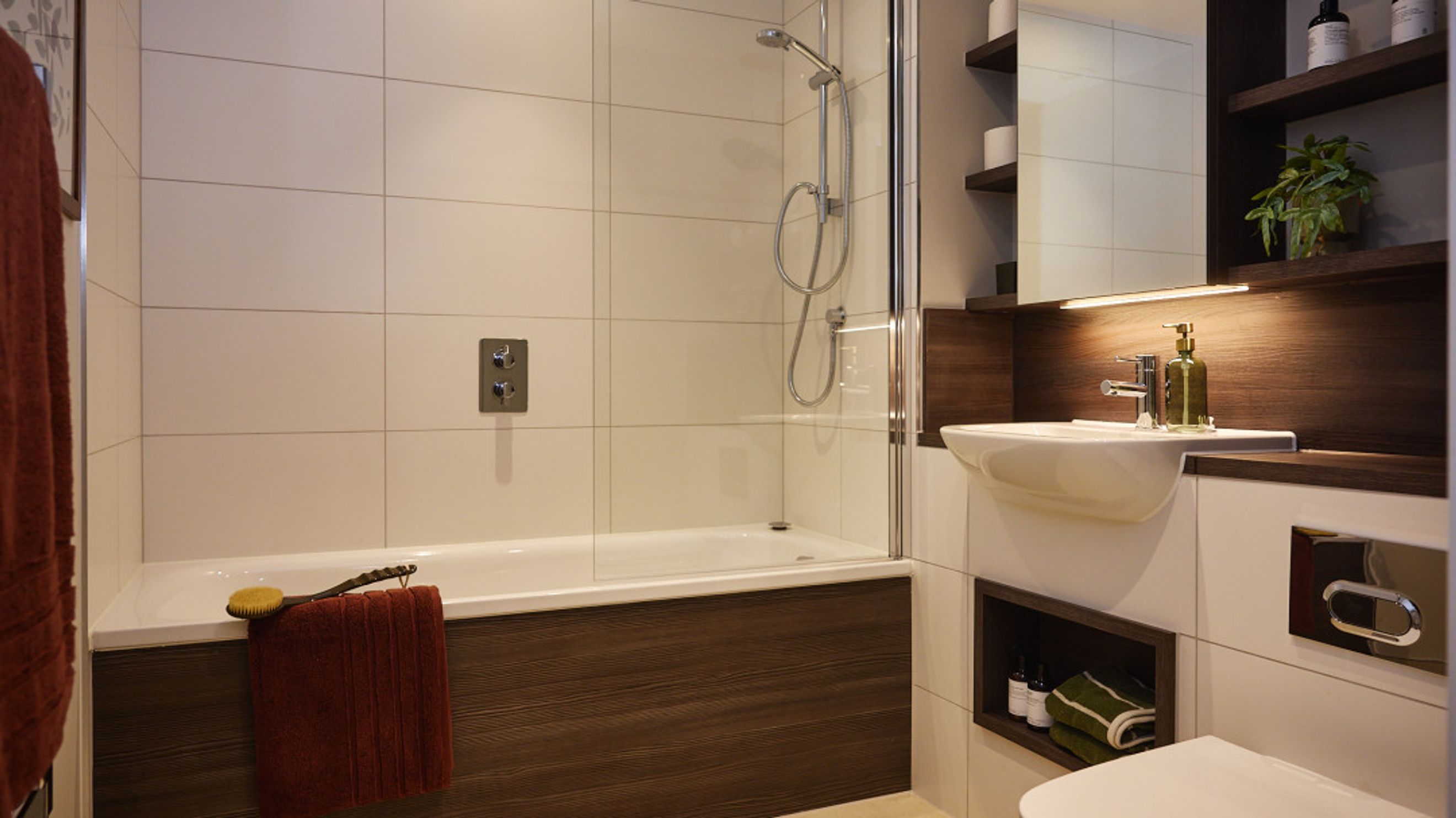 A bathroom with a bathtub, shower, and sink.